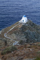 Greece, Cyclades, Islands, Sifnos Island, The Seven Martyrs a small white church with a blue dome, white crosses and old copper made green bells situated beneath Kastro village.