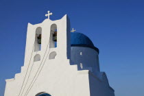 Greece, Cyclades, Islands, Sifnos Island, The Seven Martyrs a small white church with a blue dome, white crosses and old copper made green bells situated beneath Kastro village.