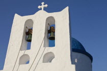 Greece, Cyclades, Islands, Sifnos Island, The Seven Martyrs a small white church with a blue dome, white crosses and old copper made green bells situated beneath Kastro village.