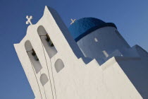 Greece, Cyclades, Islands, Sifnos Island, The Seven Martyrs a small white church with a blue dome, white crosses and old copper made green bells situated beneath Kastro village.