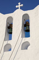 Greece, Cyclades, Islands, Sifnos Island, The Seven Martyrs a small white church with a blue dome, white crosses and old copper made green bells situated beneath Kastro village.