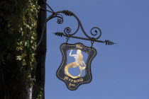 England, East Sussex, Rye, The Mermaid Inn pub sign against blue sky.