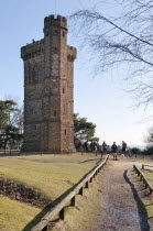 England, Surrey, Dorking, Leith Tower with walkers in mid winter.