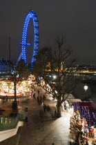 England, London, Southbank, Christmas market and the London Eye illuminated at night.