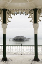 England, East Sussex, Brighton, West Pier ruin photographed from the Bedford square bandstand, known locally as the Birdcage.