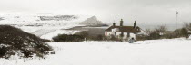 England, East Sussex, Seven Sisters, Snow covered chalk cliffs viewed from the coastguard cottages at Cuckmere Haven.