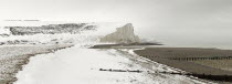 England, East Sussex, Seven Sisters, Snow covered chalk cliffs viewed from the coastguard cottages at Cuckmere Haven.