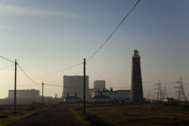 England, Kent, Romney Marsh, Dungeness, Silhouetted Nuclear power station and lighthouse.