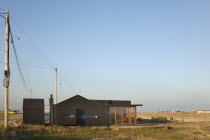 England, Kent, Romney Marsh, Dungeness, Old fishermans cottage covered in black rubberised weatherproofing.