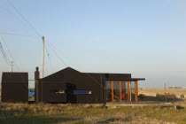 England, Kent, Romney Marsh, Dungeness, Old fishermans cottage covered in black rubberised weatherproofing.