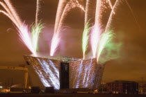 Ireland, North, Belfast, Titanic Quarter, Visitor centre designed by Civic Arts & Eric R Kuhne, illuminated during opening fireworks and projection display.