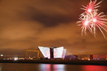 Ireland, North, Belfast, Titanic Quarter, Visitor centre designed by Civic Arts & Eric R Kuhne, illuminated during opening fireworks and projection display.