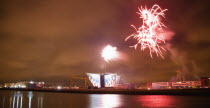 Ireland, North, Belfast, Titanic Quarter, Visitor centre designed by Civic Arts & Eric R Kuhne, illuminated during opening fireworks and projection display.