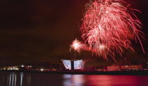 Ireland, North, Belfast, Titanic Quarter, Visitor centre designed by Civic Arts & Eric R Kuhne, illuminated during opening fireworks and projection display.