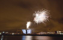 Ireland, North, Belfast, Titanic Quarter, Visitor centre designed by Civic Arts & Eric R Kuhne, illuminated during opening fireworks and projection display.