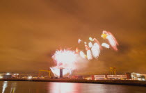 Ireland, North, Belfast, Titanic Quarter, Visitor centre designed by Civic Arts & Eric R Kuhne, illuminated during opening fireworks and projection display.