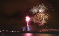 Ireland, North, Belfast, Titanic Quarter, Visitor centre designed by Civic Arts & Eric R Kuhne, illuminated during opening fireworks and projection display.