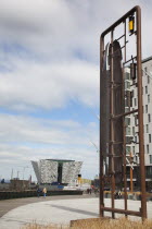 Ireland, North, Belfast, Titanic Quarter, Visitor centre designed by Civic Arts & Eric R Kuhne, with model making toy sculpture in the foreground.