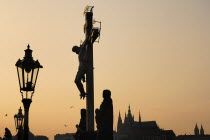 Czech Republic, Bohemia, Prague, Charles Bridge, Calvary with St Vitus in the background at dusk.