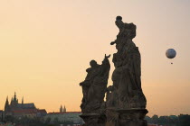 Czech Republic, Bohemia, Prague, Charles Bridge, Statue of the Madonna attending to St. Bernard with St Vitus in distance.