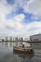 Ireland, North, Belfast, Titanic Quarter, tour boat taking tourists on sightseeing cruise.