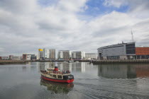 Ireland, North, Belfast, Titanic Quarter, tour boat taking tourists on sightseeing cruise.