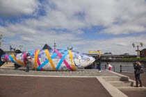 Ireland, North, Belfast, Donegall Quay The Big Fish Sculpture by John Kindness. The scales of the fish are pieces of printed blue tiles with details of Belfasts history. The 10 metre long structure is...