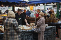 Ireland, North, Belfast, St Georges Market, stall selling, olives, cheese and preserves.
