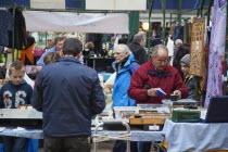 Ireland, North, Belfast, St Georges Market, stall selling coins and currency.