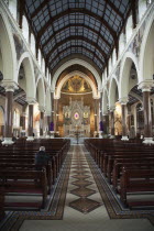 Ireland, North, Belfast, Falls Road, Clonard Monastery interior decorated for Good Friday with statues draped in purple cloth.