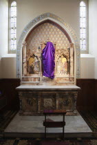 Ireland, North, Belfast, Falls Road, Clonard Monastery interior decorated for Good Friday with statues draped in purple cloth.