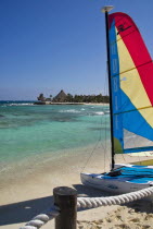 Mexico, Quintana Roo, Puerto Aventuras, View along beach with colourful hobie cats.