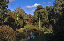 England, West Sussex, Leonardslee Lakes and Gardens, Middle Pond and autumn trees. 