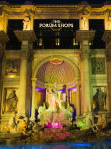 USA, Nevada, The Strip, Caesars Palace Forum Shops exterior illuminated at night.