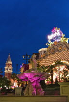 USA, Nevada, Las Vegas, Harrahs and Venetian Hotel  behind illuminated fountain.  