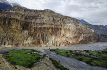 Nepal, Upper Mustang, First rays of morning light over Chhusang village.