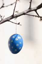 Austria, Vienna, Hand-painted egg shell hanging from a branch to celebrate Easter at the Old Vienna Easter Market at the Freyung.