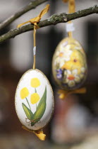 Austria, Vienna, Hand-painted egg shells hanging from a branch to celebrate Easter at the Old Vienna Easter Market at the Freyung.