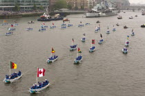 England, London, Flotilla of Sea Cadets in small boats proceeds along River Thames past HMS Belfast as part of the Queens Thames Diamond Jubilee Pageant, taken from Tower Bridge, 3rd June 2012.