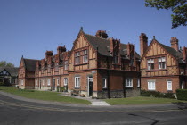 England, Merseyside, The Wirral, Port Sunlight, Red brick terraced houses on Cross street.