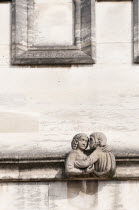 England, Oxfordshore, Oxford, Frieze of Magdalen College, Sculptured figure of a man and a woman locked in an embrace.