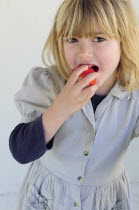 Kids, Eating, Fruit, 5 year old Eva eating first strawberries of the year in February.