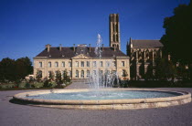 France, Haute Vienne, Limoges, Musee Municipal de l eveche with cathedral gardens on the right and fountain in the foreground.