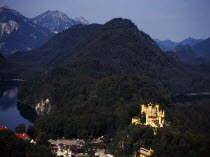 Germany, Bayern, Schwangau, view looking down on town overlooked by Schloss Hohenschwangau and Alpsee.