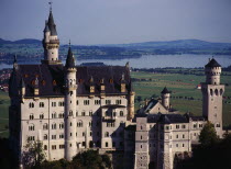 Germany, Bayern, Schwangau, Neuschwanstein castle built 1869-86 for king ludwig ii with forggensee in background.