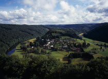 Luxembourg, Frahan, view from Rochehaut over village beside the river semois surrounded by hillsides covered by forest.