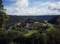Luxembourg, Frahan, view from Rochehaut over village beside the river semois surrounded by hillsides covered by forest.