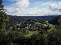 Luxembourg, Frahan, view from Rochehaut over village beside the river semois surrounded by hillsides covered by forest.