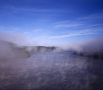 France, Bretagne, RiverAaulne, view from pont de terenez bridge looking west along river in dawn fog.