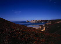 France, Bretagne, Crozon Peninsula, Pointe de Penhir, from above veryach beach with braken covered cliff in foreground.